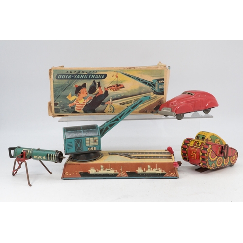 88 - Toys: Boxed Automatic dock yard crane made in Germany, clockwork tank, tin plate fire car siren and ... 