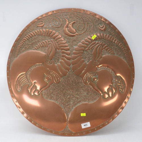 403 - A large circular copper panel featuring two rams clashing horns