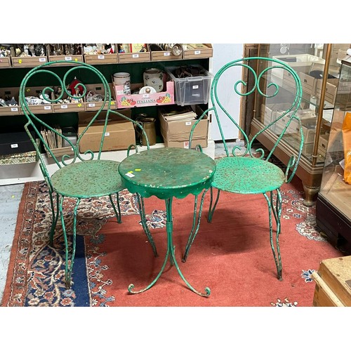 467 - Two green painted metal garden chairs together with similar table