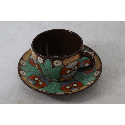 15 - A Swiss Thoune Majolica cup and saucer together with a slipware cup and saucer.