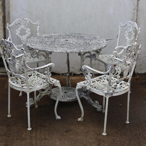 70 - Painted metal garden table measures approx. 91cm dia together with four chairs.