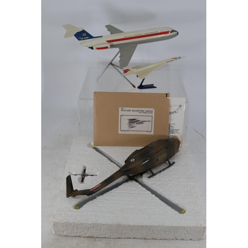 106 - Boxed helicopter together with a model of Concorde on stand and a BAC passenger plane on stand