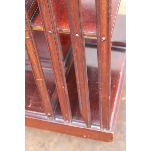 221 - Revolving bookcase (note damage to one side) measures approx. 47cm x 47cm x 87cm h