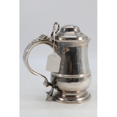 31 - An 18th Century antique silver hallmarked lidded tankard (approx. 780g) with matching hallmarks to b... 