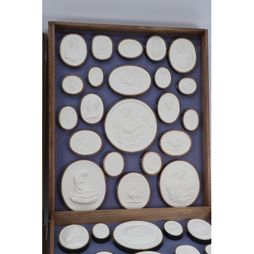 88 - Vintage series of Grand Tour Intaglio plaster seals in four oak stacking trays.