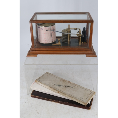 146 - A cased Barograph with three packs of paper.