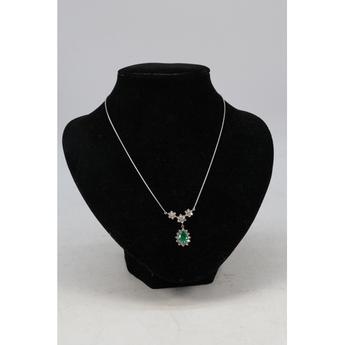 182 - An 18ct white gold necklace with attached pendant comprising of Emerald Teardrop surrounded by diamo... 