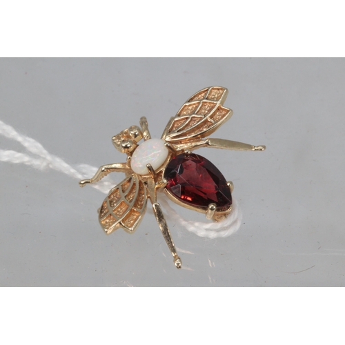 184 - 9ct gold wasp brooch with opal and garnet