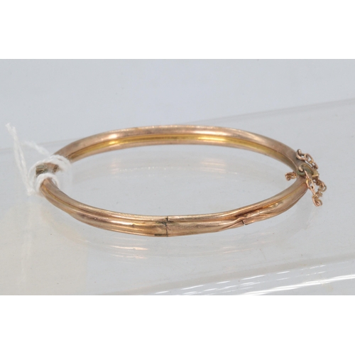 219 - A 9ct gold bangle (dented) (approx. weight 5.7g)