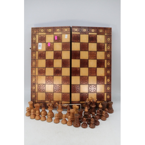 463 - A folding wooden chess board complete with pieces