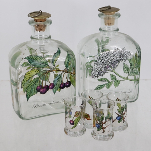 11 - Two fruit liqour decanters with four glasses