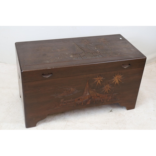 121 - Oriental carved camphor wood trunk measures approx. 90cm w x 44cm d x 50cm h