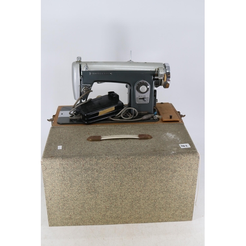 124 - Cased Singer 359 sewing machine together with a Universal cased electric sewing machine TRADE/SPARES... 