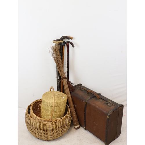 256 - Vintage suitcase together with a selection of baskets and walking sticks and a pair of Dr Martens bo... 