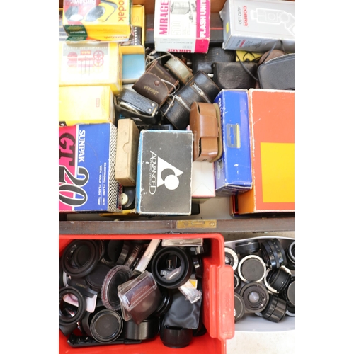 129 - Large quantity of cameras accessories, lenses, flashes etc together with a cased scale