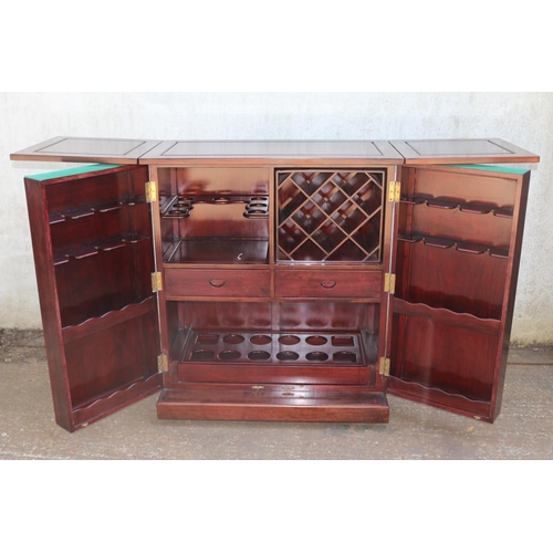 206 - Mobile Rosewood drinks cabinet with oriental motif to front and rear measures approx unextended 91.5... 