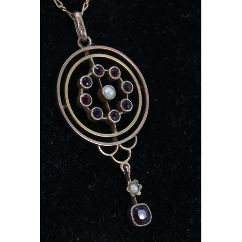 248 - A 9ct gold necklace with 9ct gold pendant set with a seed pearl and small garnets (approx. weight 4.... 