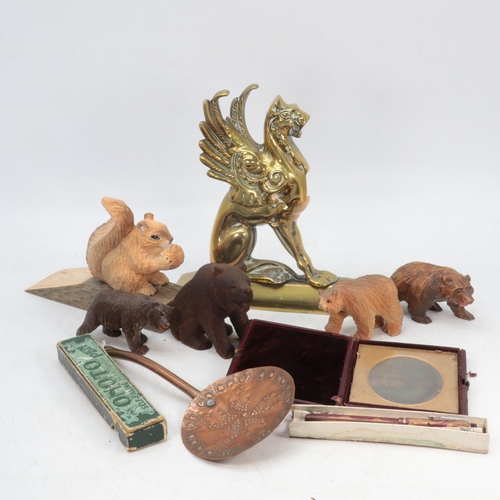 688 - Brass Griffin shaped door stop together with some carved black forest style bears, wooden carved squ... 