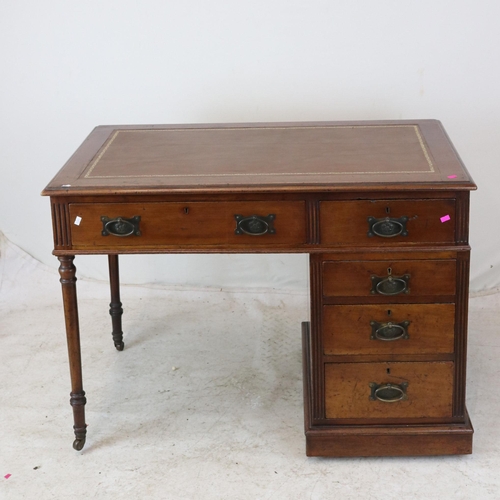 168 - A kneehole lether-topped desk with bank of drawers to the right. It measures approx. 106W x 64D x 77... 