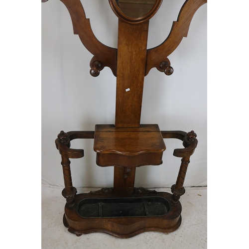 279 - Antique hall stand with drip tray, key box, mirror and eight coat hooks (note-damage repair to one o... 