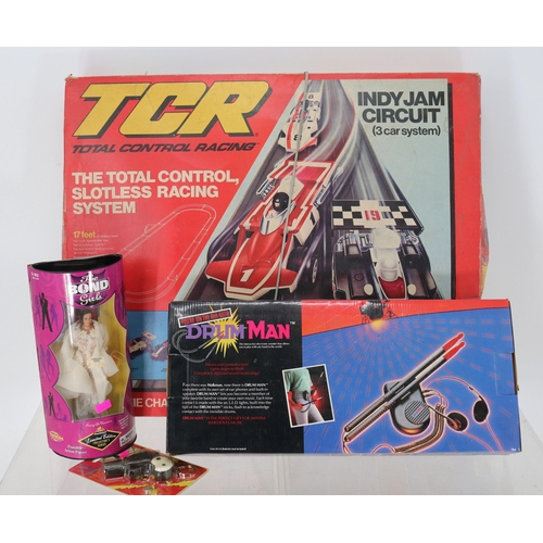 398 - Boxed DrumMan with original box together with TCR slotless racing system, James Bond girl and a Jame... 