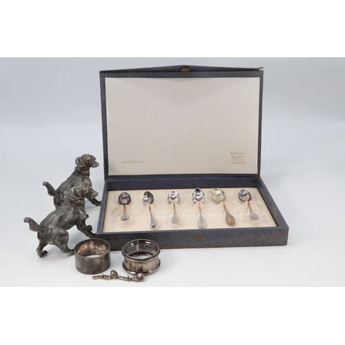 31 - Two pewter pepperettes in the form of dogs, two silver napkin rings and a set of six small 800 grade... 