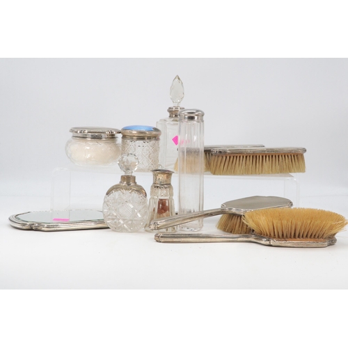 59 - A selection of silver backed vanity items including a scent bottled etc