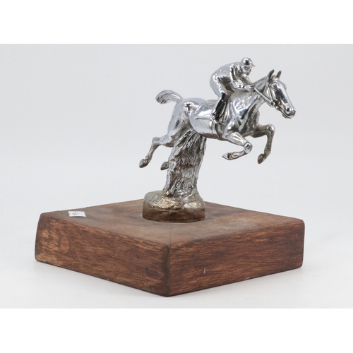 78 - A chromed, jockey and horse/car mascot on wooden plinth (approx. height 16cm)