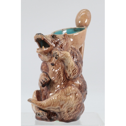 85 - A Majolica honey bear jug with fixed spoon handle (noted small chip to base) (approx. height 17cm)