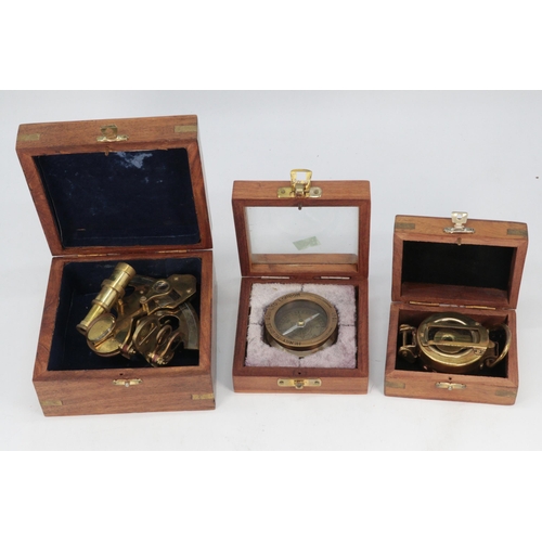 90 - Wooden cased reproduction sextant together with two similar compasses