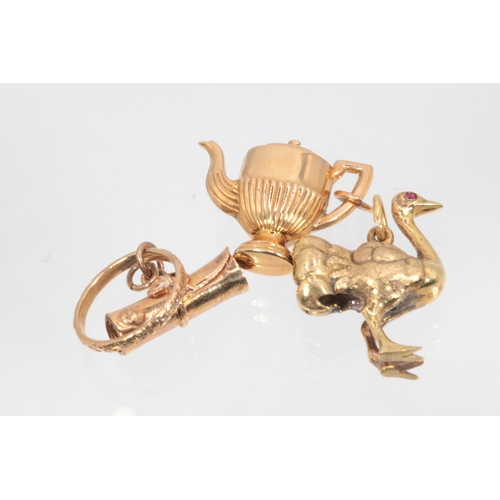 232 - Three 9ct gold charms to include a teapot, a scroll and ring, and an ostrich (approx. weight 9.7g)