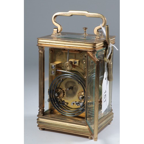 161 - A brass cased French carriage clock with alarm and key