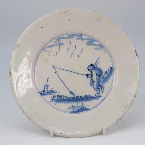 59B - A English Delft? ceramic plate depicting a boy fishing (measures approx. 21cm diameter) noted hairli... 