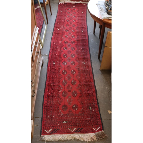 104 - Oriental runner with red ground measures approx. 73cm x 395cm