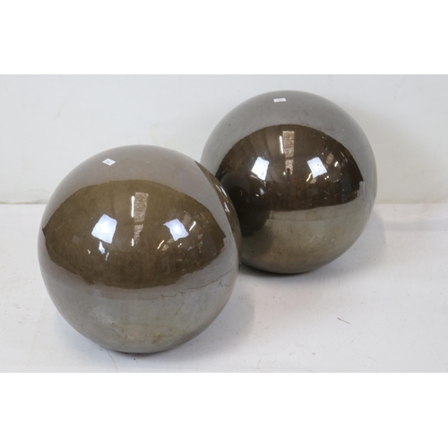 386 - A pair of glossy garden pottery spheres. Approx. 33cm tall.