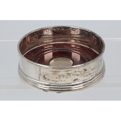 20 - A small silver hallmarked  bottle coaster (approx. total, weight 84g and 9cm diameter)