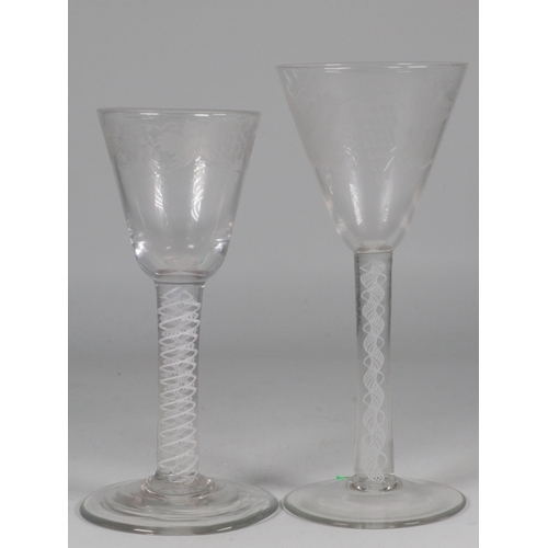 60 - Two antique engraved wine glasses with twist stems