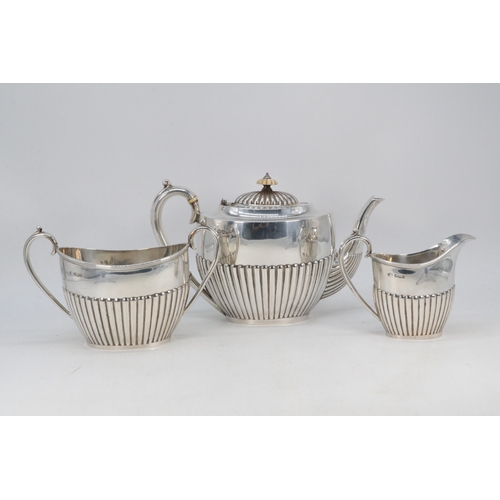 10A - Silver hallmarked three piece tea set, the teapot has ivory insulators, all three items assayed Shef... 