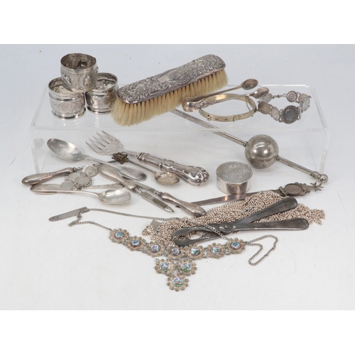 764 - A selection of white metal and plated cutlery, napkin rings etc