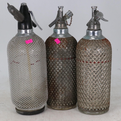 24 - Three soda syphons all cased in metal