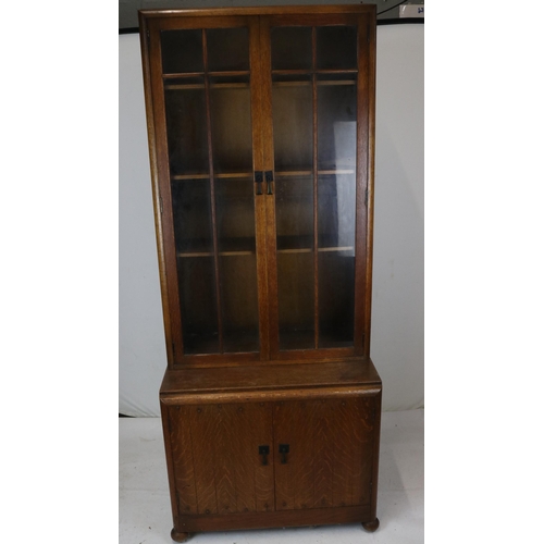 35 - Cupboard with glazed bookcase above measures approx. 76cmW x 46cmD x 185cmH