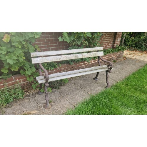 419 - A pair of garden benches with cast ends resembling horses hooves. Measuring approx. 150cm