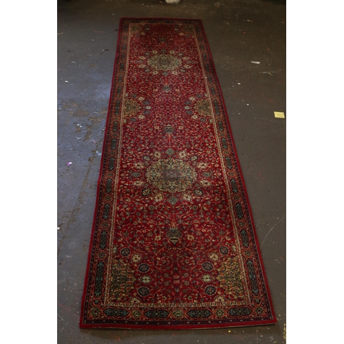 392A - Red ground Wilton rug measures approx. 12 x 3