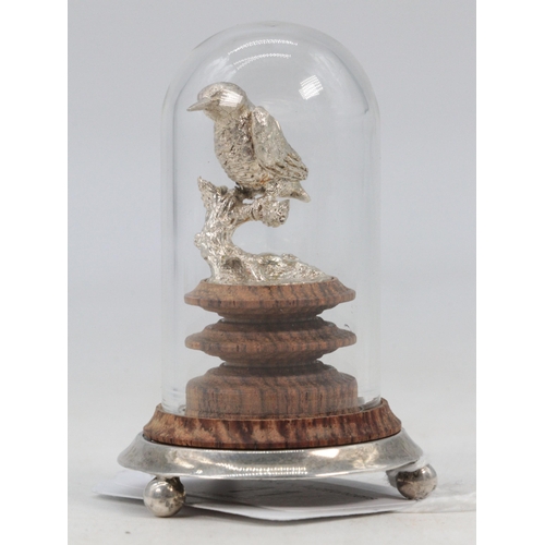 11 - A miniature silver hallmarked bird on turned wooden plinth set into silver footed base with a glass ... 