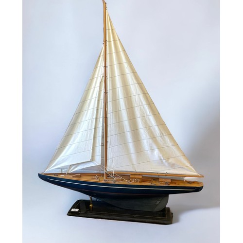 645 - A large wooden contemporary yacht on fixed wooden stand (measures approx. 92cm x 1.1m)