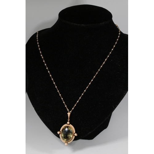 243 - 15ct gold necklace with large oval citrine? stone in a cruciform setting surrounded by miniature see... 