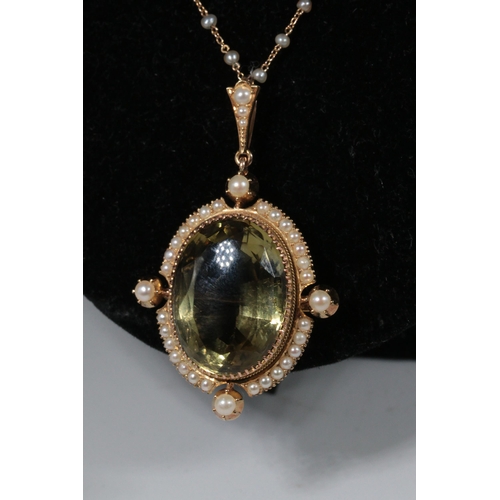 243 - 15ct gold necklace with large oval citrine? stone in a cruciform setting surrounded by miniature see... 