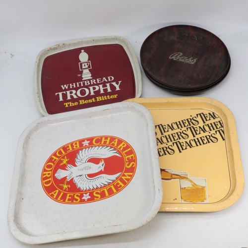 516 - A quantity of vintage and later tin trays to include Whitbread, Teachers, Whitehorse etc