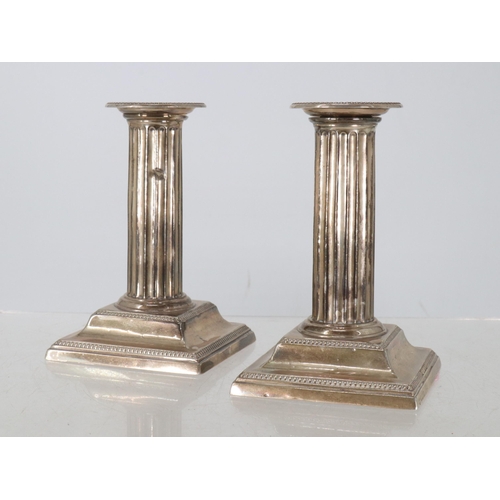 5 - Pair of silver hallmarked column candlesticks, weighted.