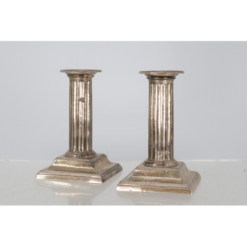 5 - Pair of silver hallmarked column candlesticks, weighted.